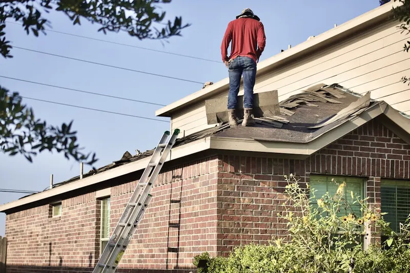 Professional roofer working on a residential roof in Gwynedd Lea